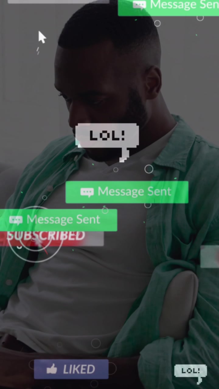 Animation of social media icons over african american man using laptop sitting on the couch at home