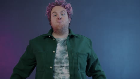 man posing with pink hair and green jacket
