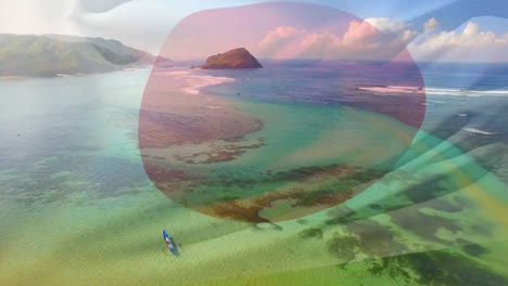 Digital-composition-of-waving-japan-flag-against-aerial-view-of-sea-waves