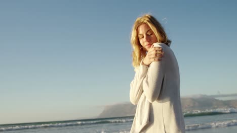 young woman walking on shore at beach