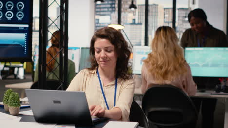 vertical video businesswoman evaluates key performance metrics and writes reports