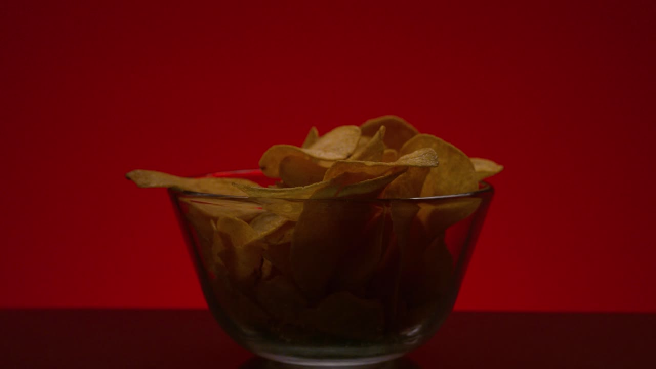 Crispy Potato Chips in a Glass Bowl