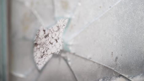 close-up of broken glass window with cracks