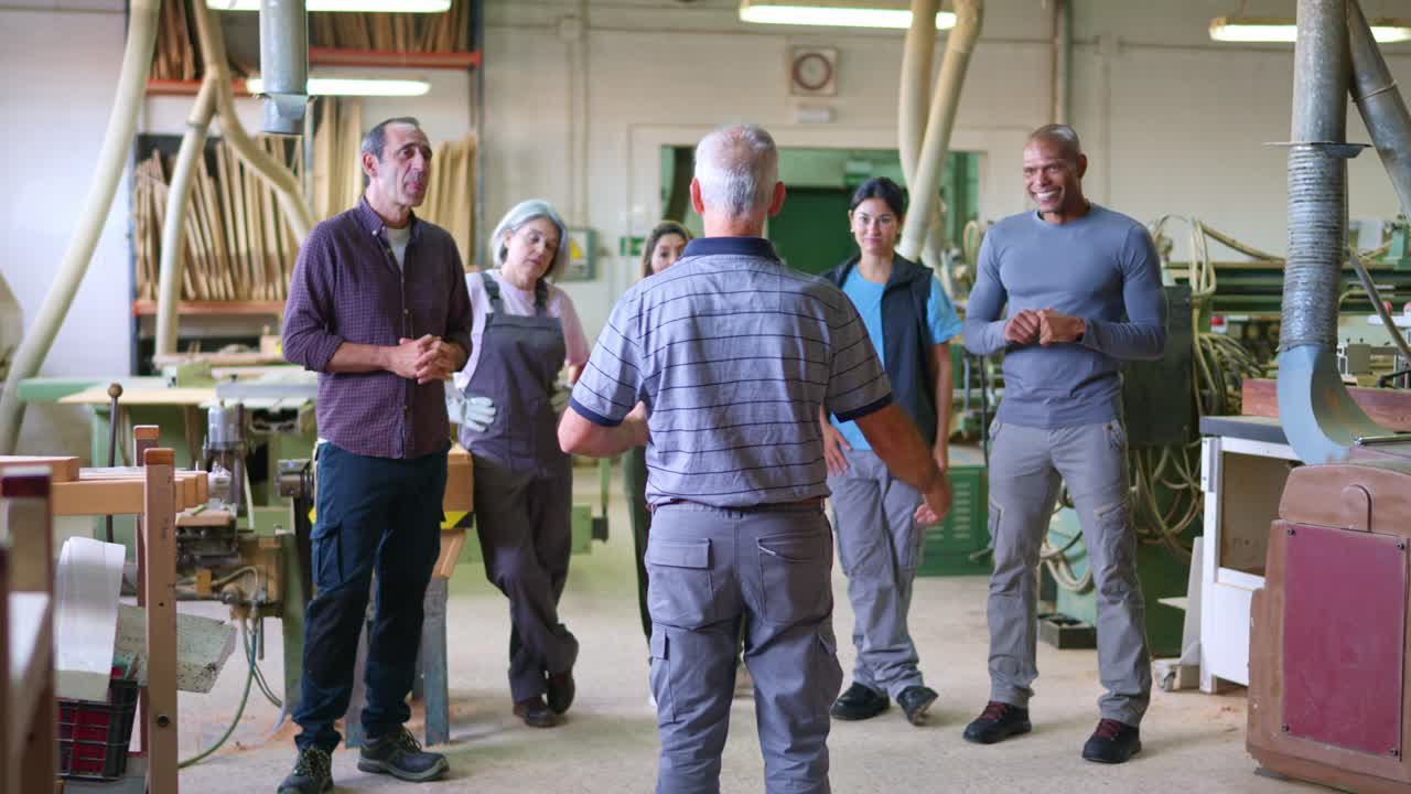 Diverse Group of Woodworkers Having a Meeting in a Carpentry Workshop