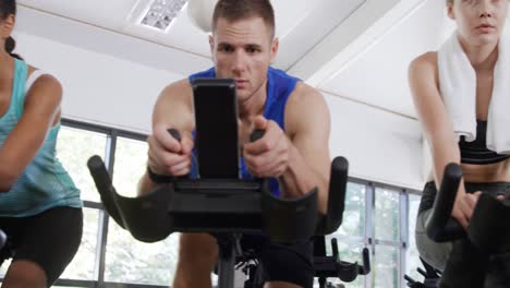 working out on exercise bikes at a gym