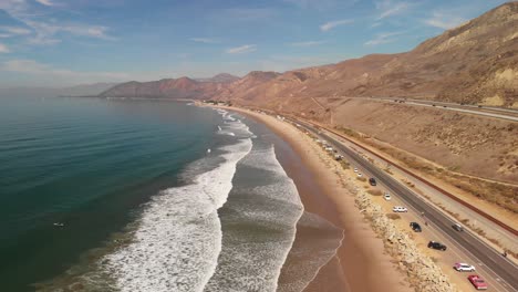 Aerial-shot-of-of-the-Pacific-Coast-Highway-along-California-beach