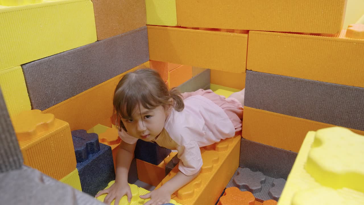 Excited Toddler Girl Play With Huge Construction Toy Blocks - Crawling Through Hole in Wall