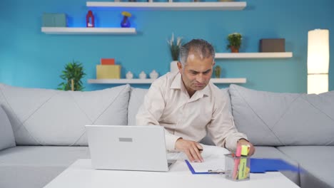 home office worker man examining, analyzing documents.