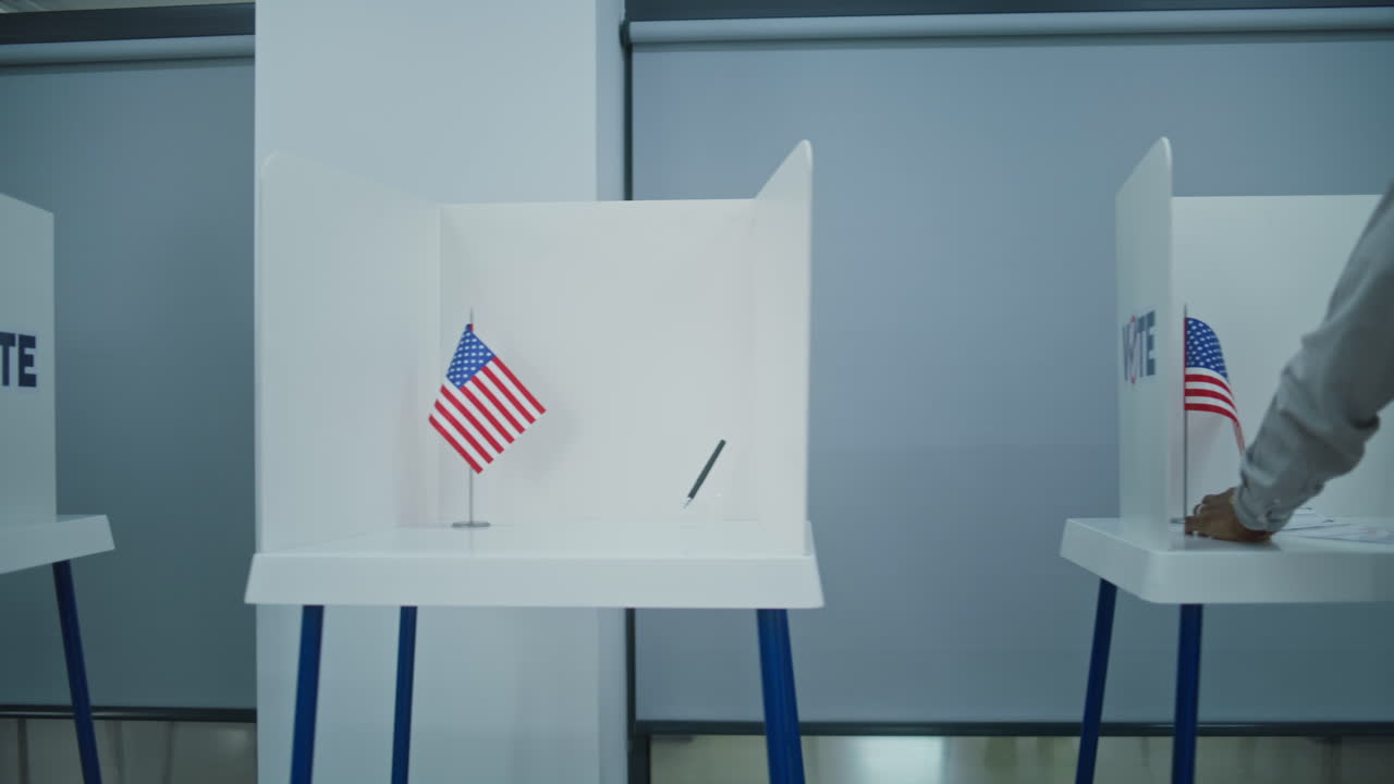 Dolly Shot of Diverse American Citizens Voting in Booths Dolly Shot of Diverse American Citizens Voting in Booths in Polling Station Office National Election Day in the United States Political Races of us Presidential Candidates Concept of Civic Duty