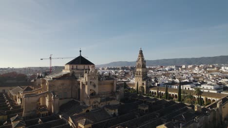 mezquita cathedral of cordoba in spain with crane in background. aerial drone panoramic view. sky for copy space