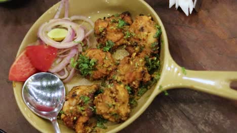 chicken dish served in decorated plate with salad from top angle