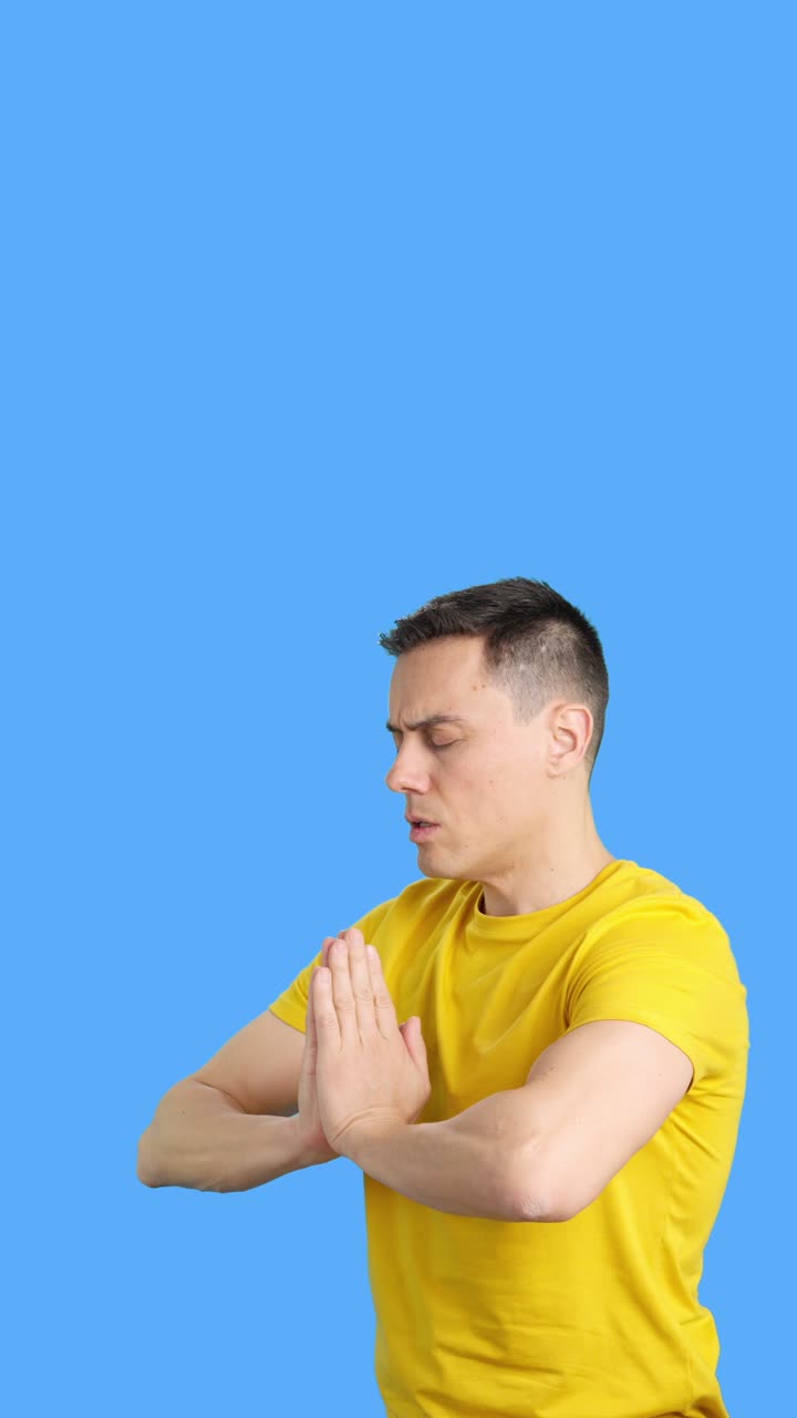 Man meditating with hands together