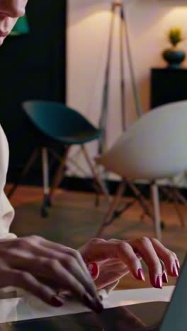 close-up video of hands typing on a laptop, side angle
