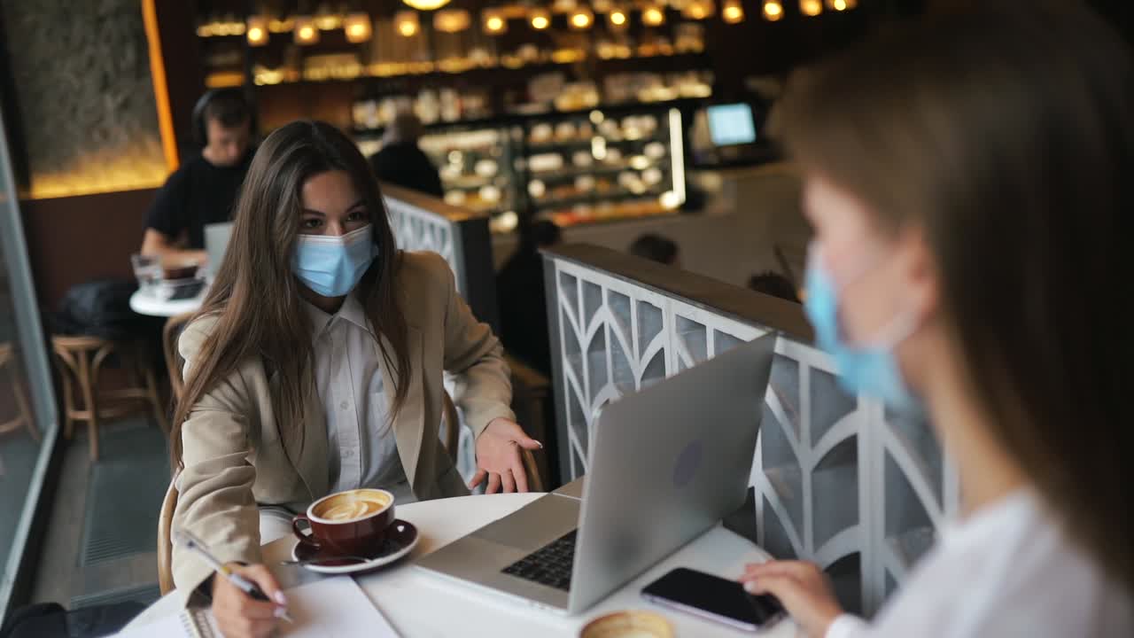 mujeres de negocios se reúnen en un café.