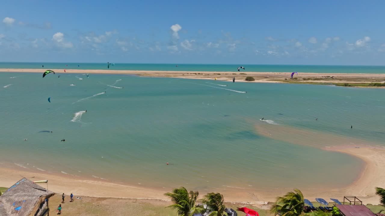 Revealing shot of the lagoon of Ilha do Guajiru with kitesurfers in the background