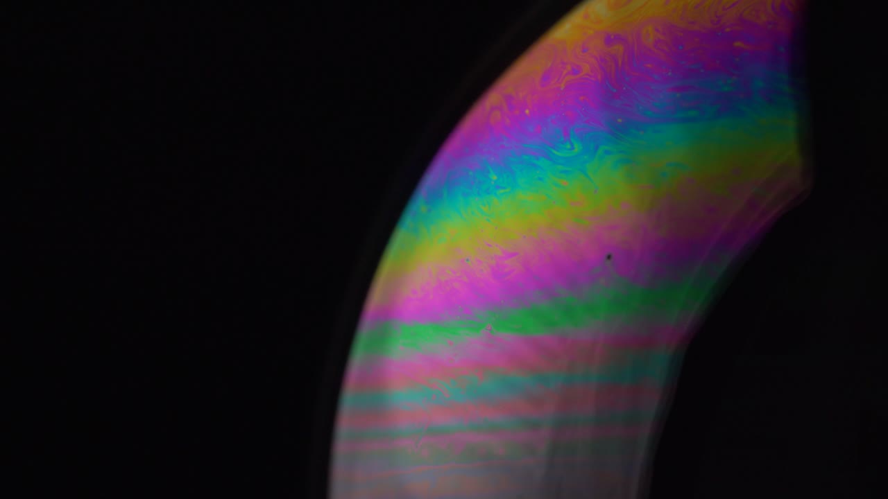 Dive into the abstract realm of soap bubbles, where close-up shots reveal mesmerizing swirls and splashes of color.