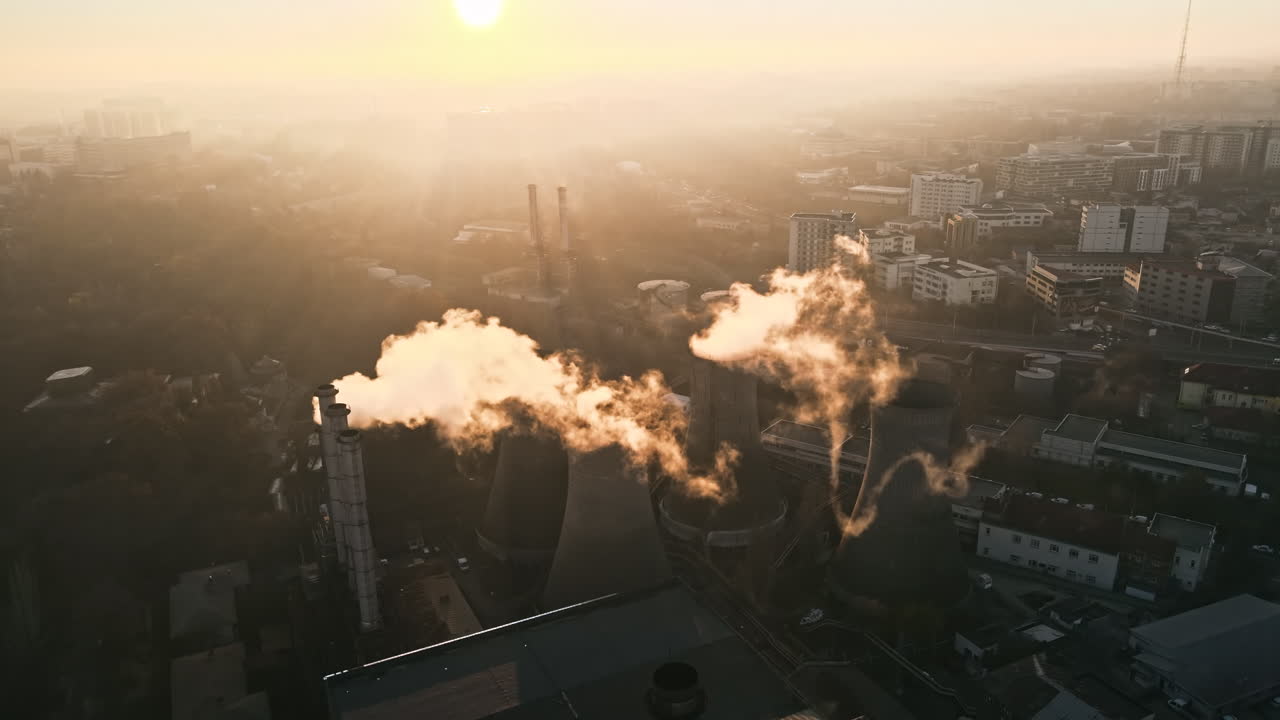 Power station with a lot of tubes and facilities in Bucharest at sunset, a lot of foam. Cityscape, view from the drone, Romania