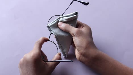 cleaning eyeglasses with a cloth