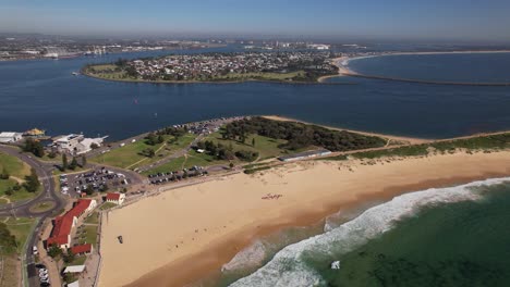 aerial view of nobbys beach at sunset in new south wales, australia - drone shot