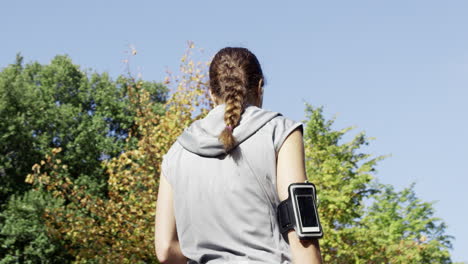 runner woman drinking water bottle sun flare solar energy