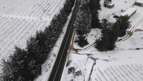 Aerial-view-of-snow-covered-landscape-and-vineyards-with-two-lane-road,-Israel