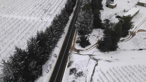 aerial view of snow covered landscape and vineyards with two lane road, israel