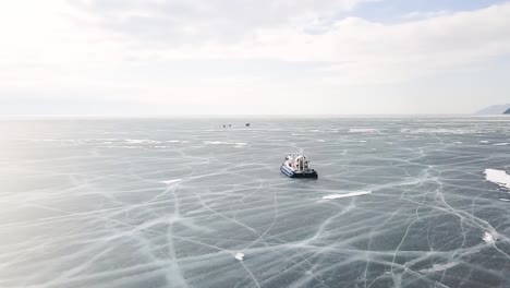 frozen lake with boat and people