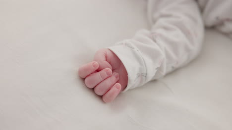 Hand,-baby-and-sleeping-on-bed-in-nursery