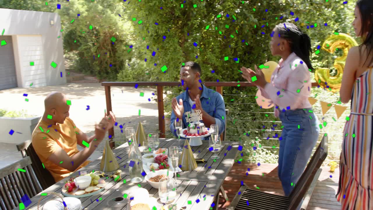 Woman bringing cake toward seated honoree on deck, confetti overlay marking birthday celebration
