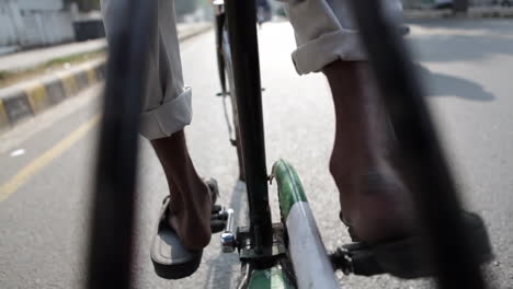 bicycle rickshaw. his  feet are paddling