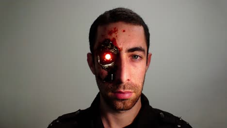 cinemagrama de luz roja parpadeando desde el ojo de un hombre humanoide ciborg