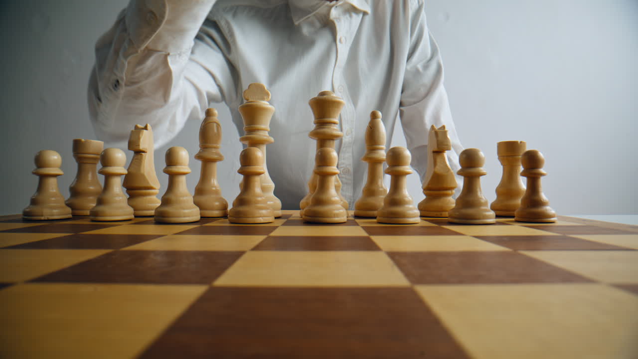 Player hand moving figure in strategy game closeup. Chess logic tactic board game