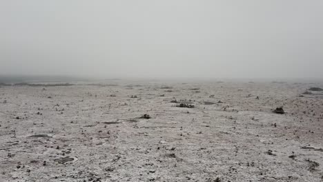 aerial drone view of an empty large and wide bog field covered in snow