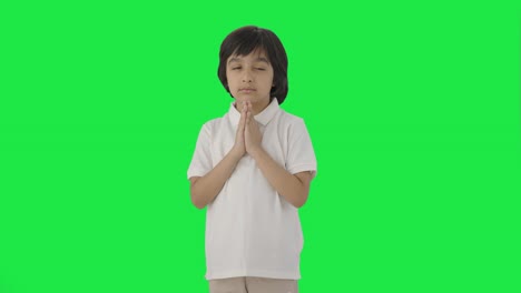 cute indian boy praying to god green screen