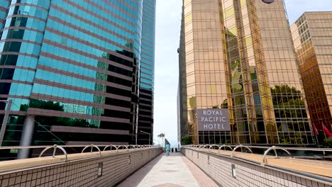 pedestrian path between tall modern buildings
