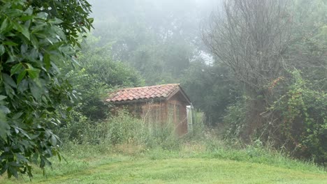 A-small-wooden-cabin-in-the-mountains-amid-thick-fog,Close-up-view