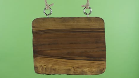 panorama, of a hanging wooden sign. isolated on green screen.