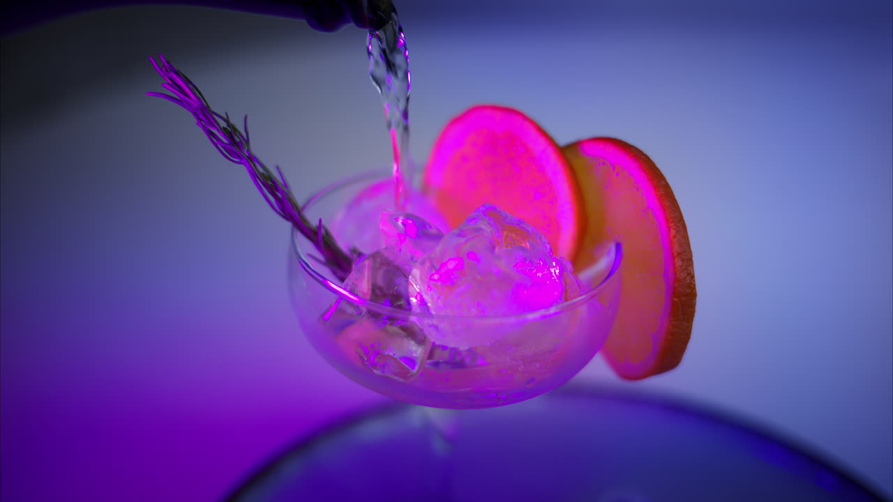 Pouring prosecco from the bottle into the glass with ice and orange slices. Close up. Neon lights