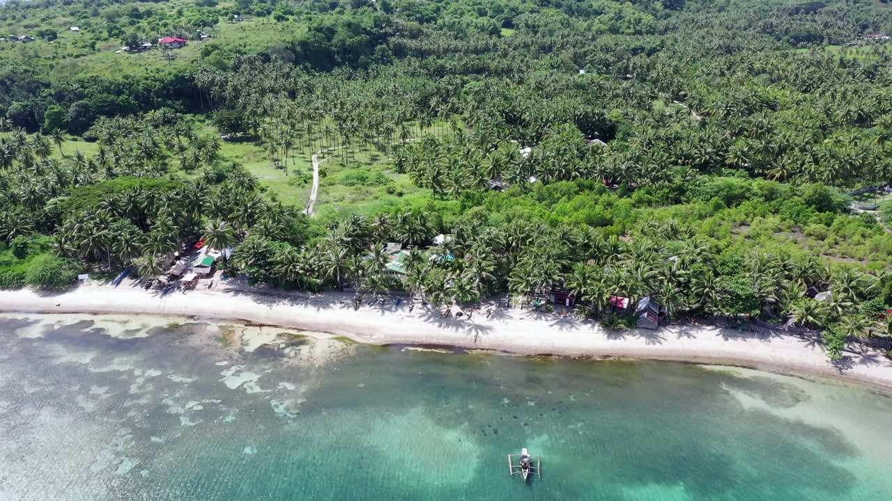 Aerial view of a beach of Philippines, in Negros Oriental, in tropical scenery with canoes. 4k