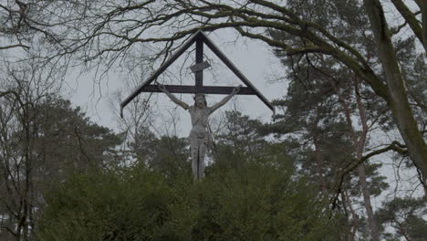 close low angle static of statue of jesus christ at graveyard