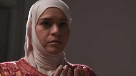 Studio-Head-And-Shoulders-Portrait-Of-Muslim-Woman-Wearing-Hijab-Praying-7