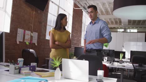 Diverse-male-and-female-business-colleagues-in-discussion-at-work