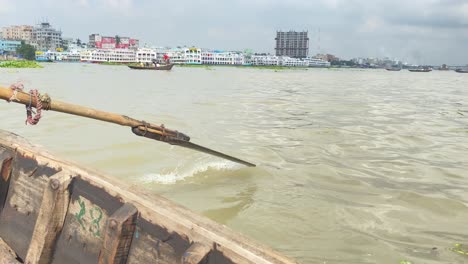 close up of rowing boat paddle in crowded buriganga river, dhaka bangladesh