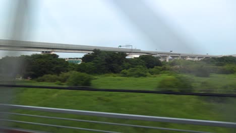 the view of tokyo passing from inside of the shinkansen bullet train