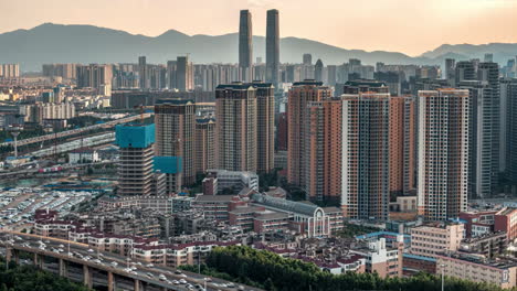 Timelapse-urban-atmosphere-of-rush-hour-traffic-jam-overpass-at-the-large-avenue-near-skyline-landmark-high-rise-building-skyscrapers-in-modern-city,-financial-business-center-downtown