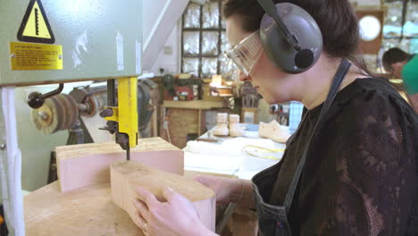 bespoke shoemaker cutting wooden last for shoe using jigsaw