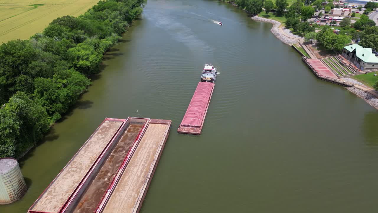 Aerial footage of a barge adding a container on the Cumberland River