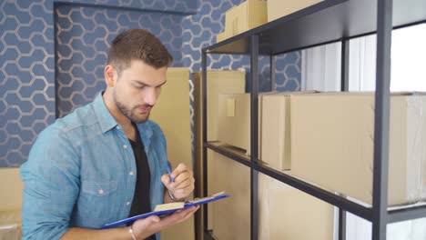 entrepreneur man selling with e-commerce organizes parcels.