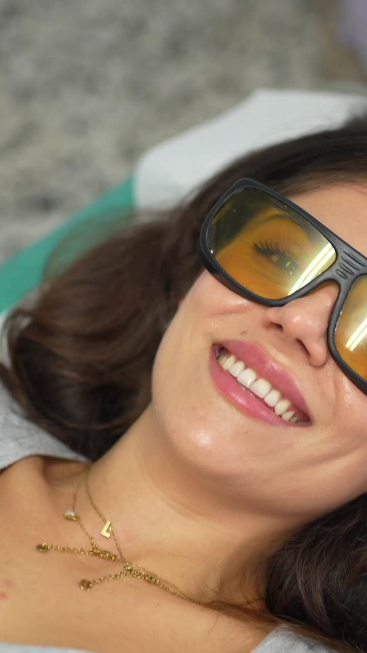 Woman undergoing laser hair removal treatment