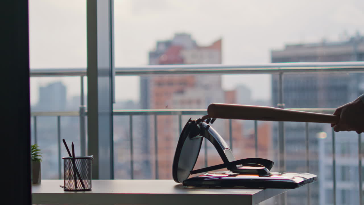 Unrecognizable executive breaking monitor with heavy bat at workspace closeup